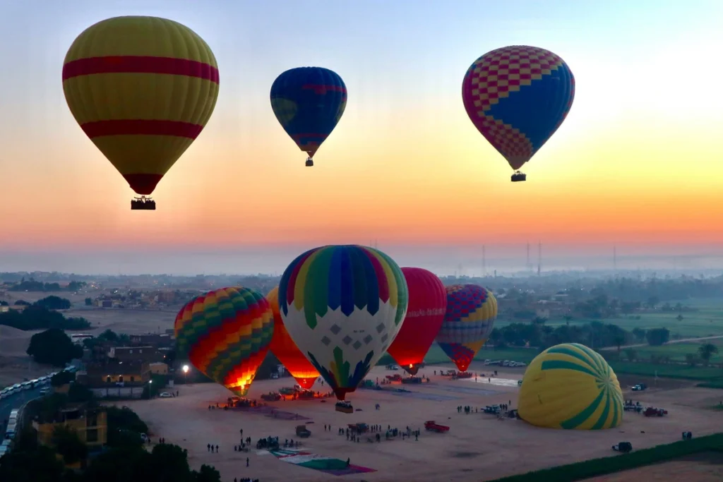 Scenic hot air balloon ride at sunrise over Luxor, Egypt.