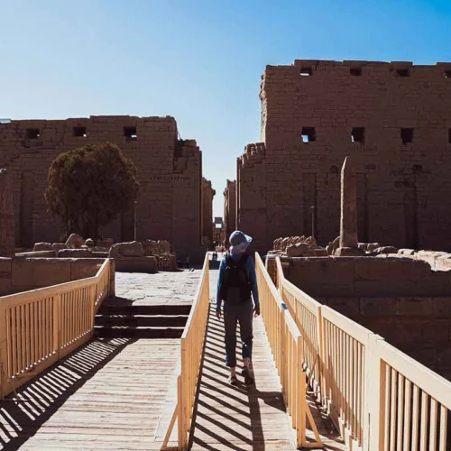 Tourist exploring the open-air museum of Karnak Temple.