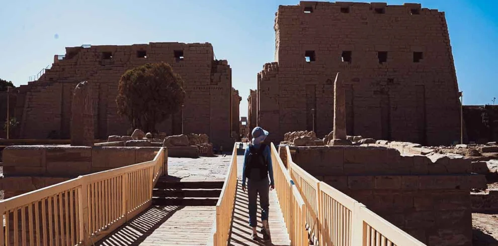 Tourist exploring the open-air museum of Karnak Temple.