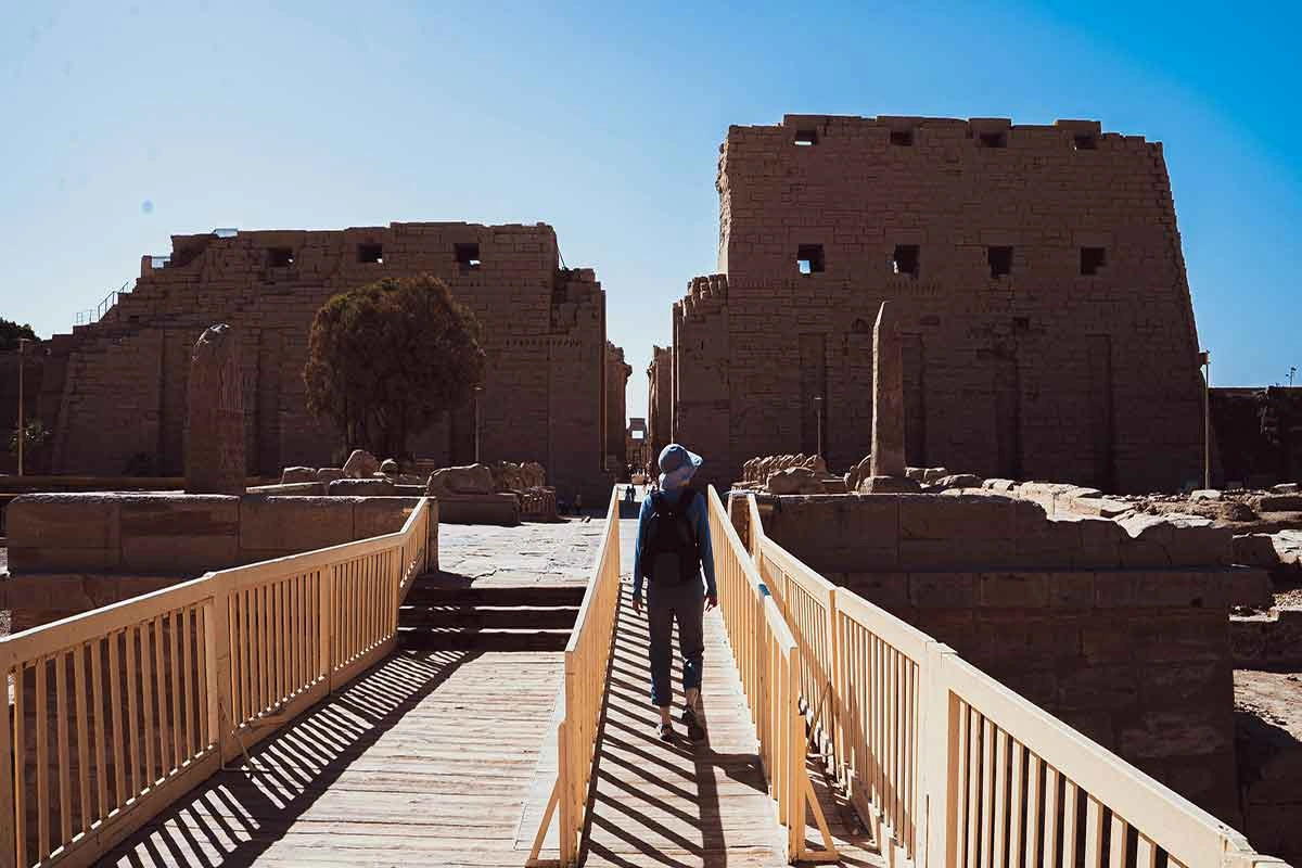 Tourist exploring the open-air museum of Karnak Temple.