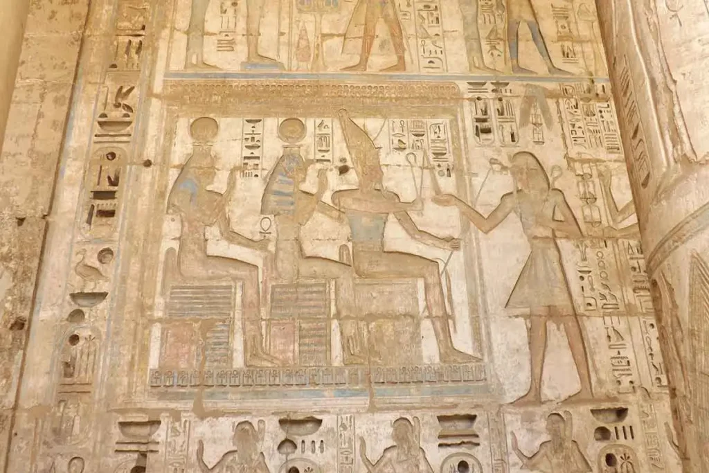 Intricate hieroglyphics and reliefs at Medinet Habu Temple.