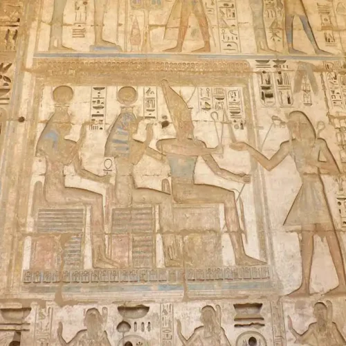 Intricate hieroglyphics and reliefs at Medinet Habu Temple.