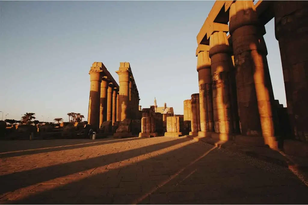 Sunset view of historic Egyptian pillars at Karnak Temple.