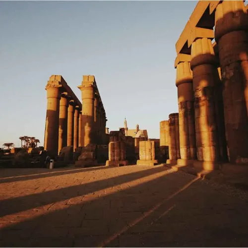 Sunset view of historic Egyptian pillars at Karnak Temple.