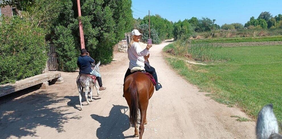 Horseback riding in Luxor’s countryside at sunset – peaceful rural experience with palm groves and village trails.