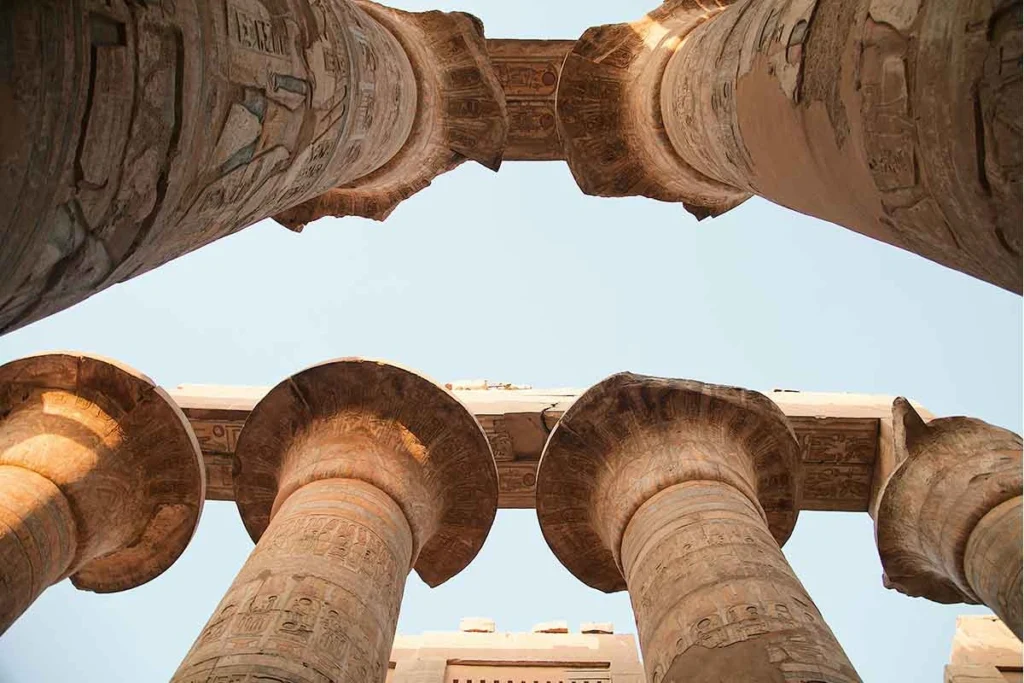 Close-up of intricately carved stone pillars at Karnak Temple.