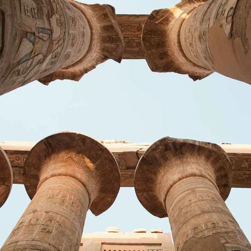 Close-up of intricately carved stone pillars at Karnak Temple.